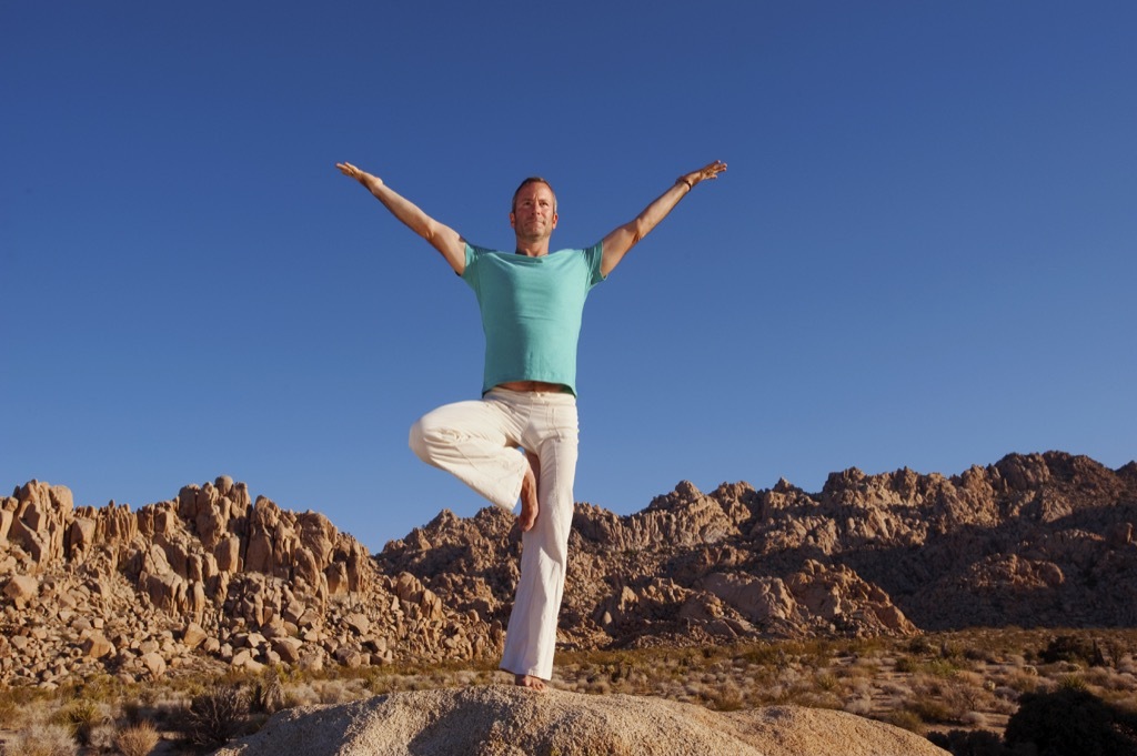 man doing yoga, tree pose