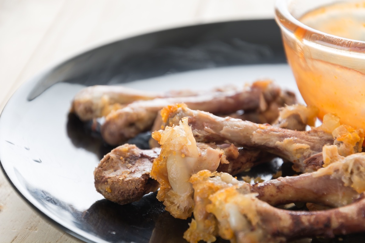 chicken bone on black plate