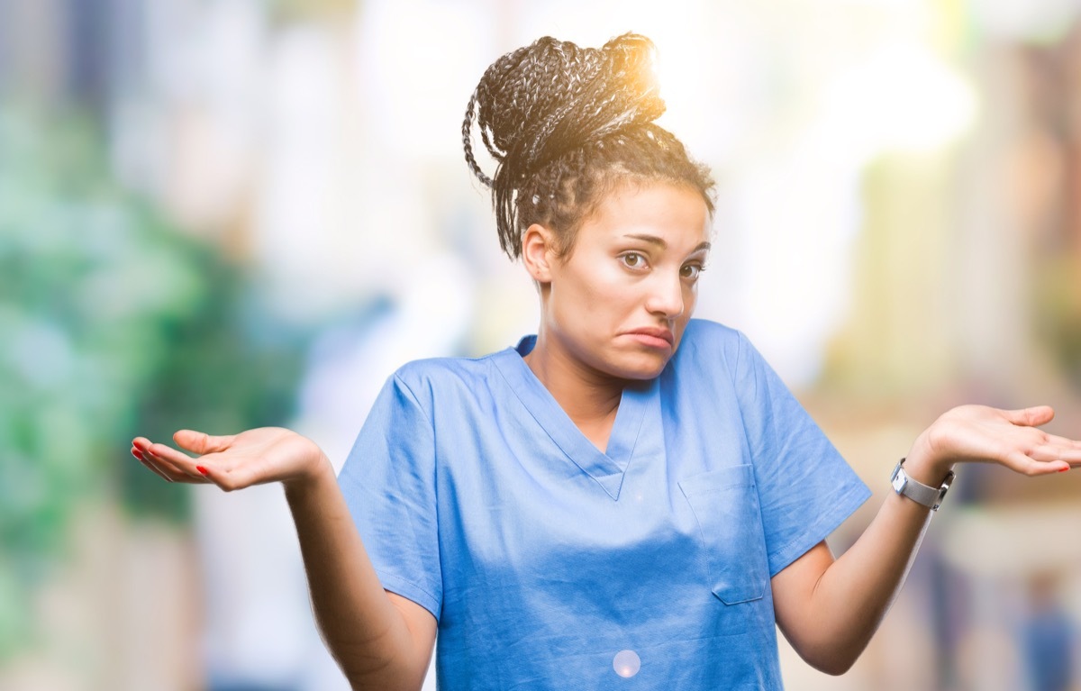 african american girl professional nurse over isolated background clueless and confused expression with arms and hands raised