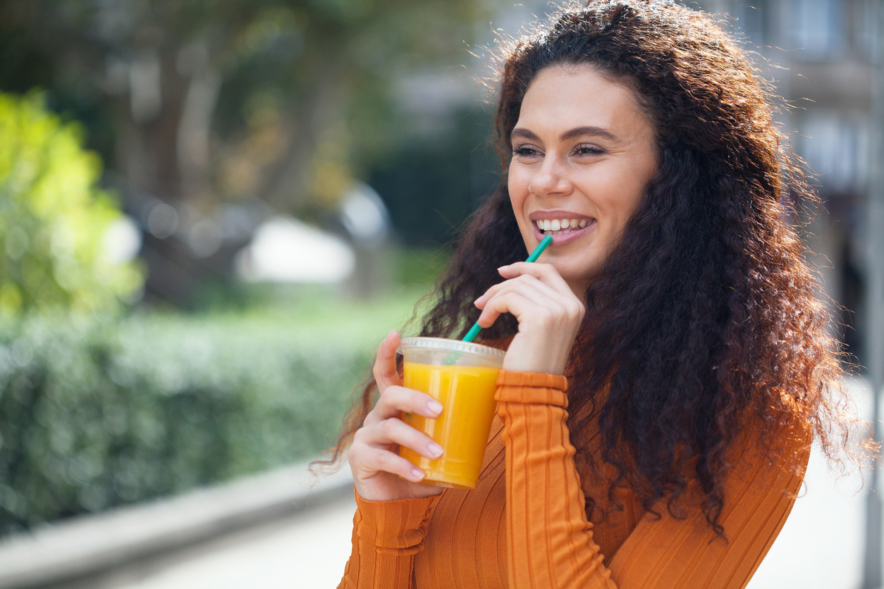 Woman drinking orange juice.