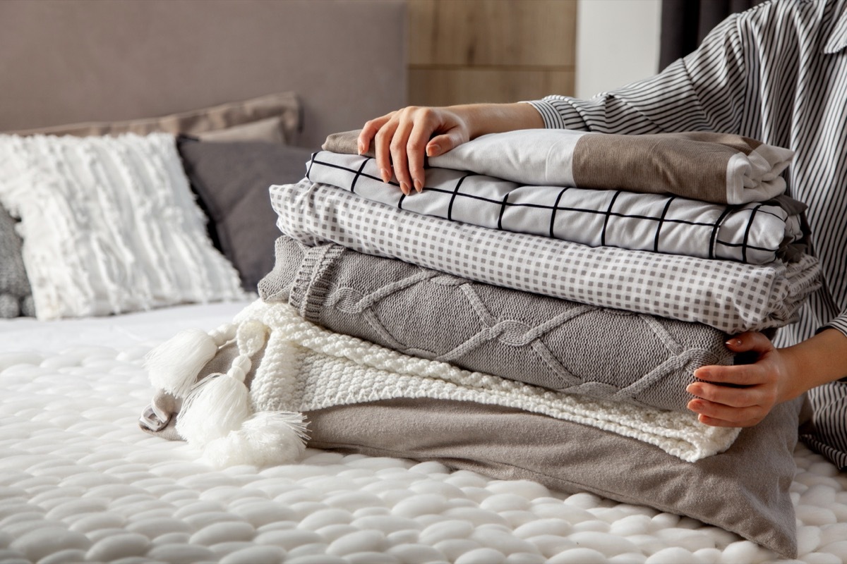 stack of blankets on bed