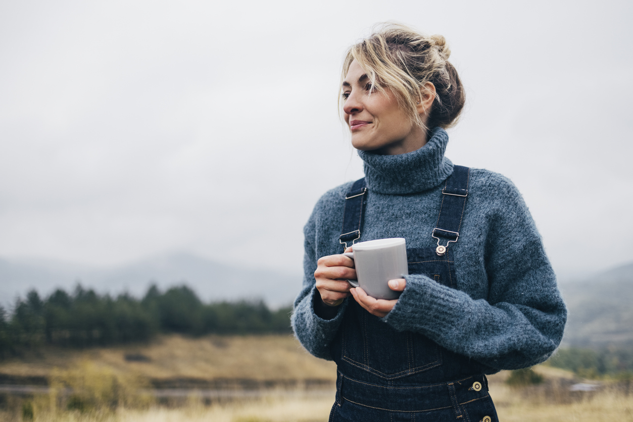Young female enjoying her cup of tea outdoors