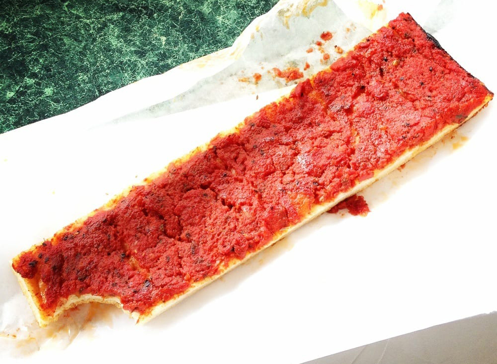 rhode island pizza strip on paper bag with lots of sauce