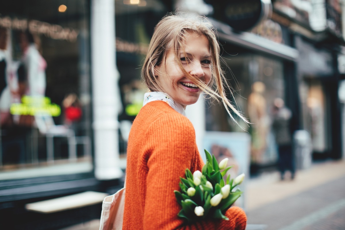 young woman holding flower bouquet