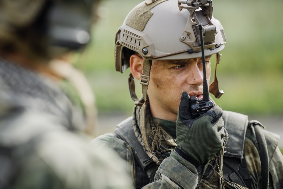 military officer talking into a walkie-talkie