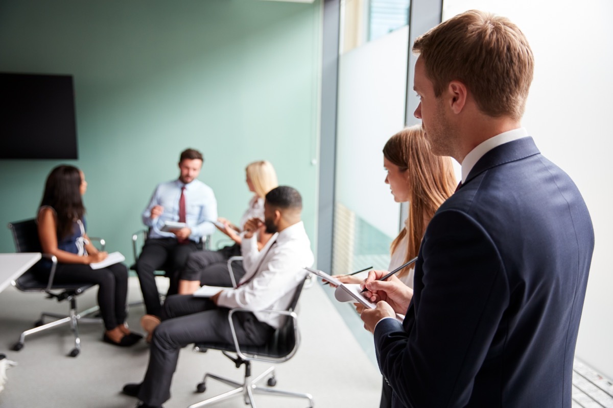 People Taking Notes From a Meeting