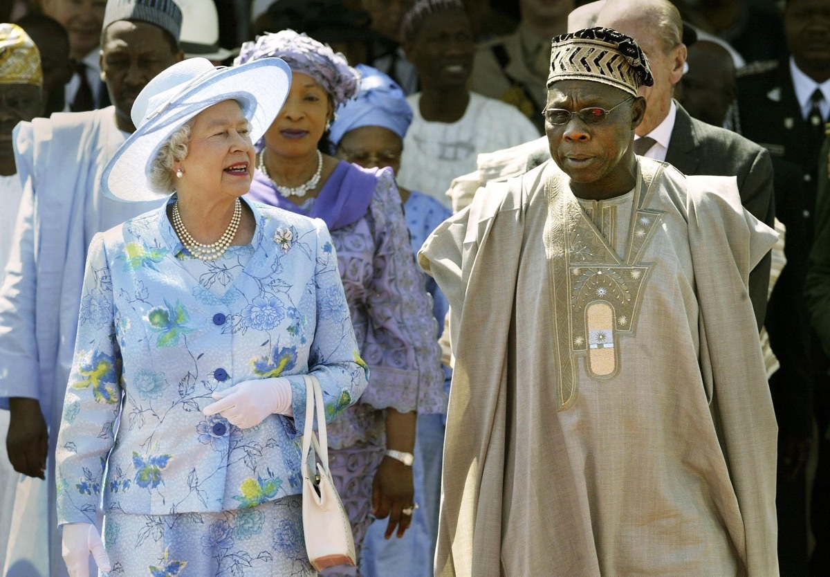 Queen Elizabeth II is escorted by Nigerian President Olusegun Obasanjo whom Prince Philip offended among controversial moments
