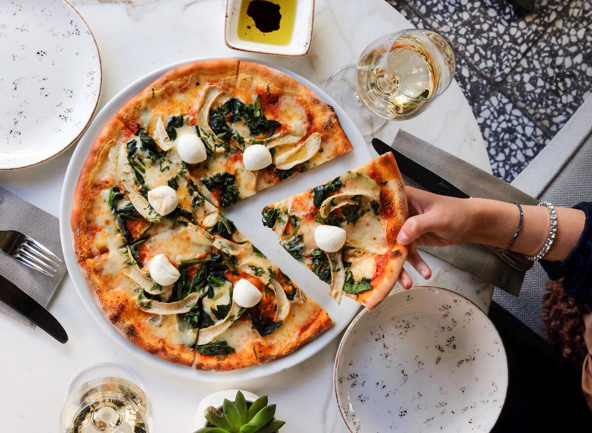 grabbing a slice of pizza