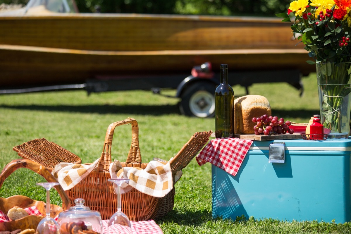 vintage A picnic at the lake house with a vintage boat in the background