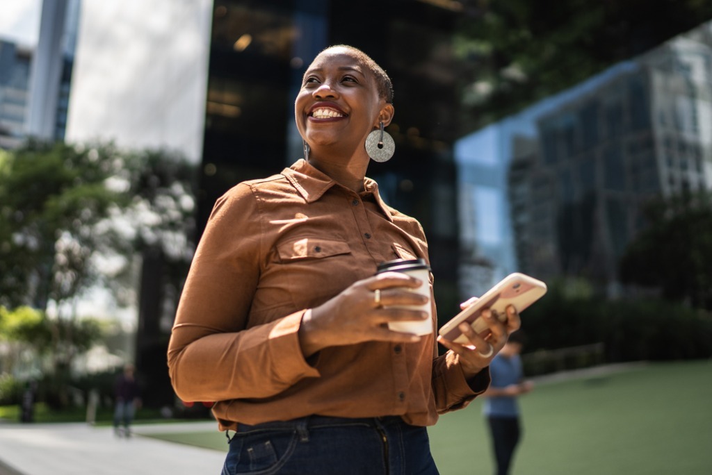 beautiful and professional looking black businesswoman smiling, looking optimistic 