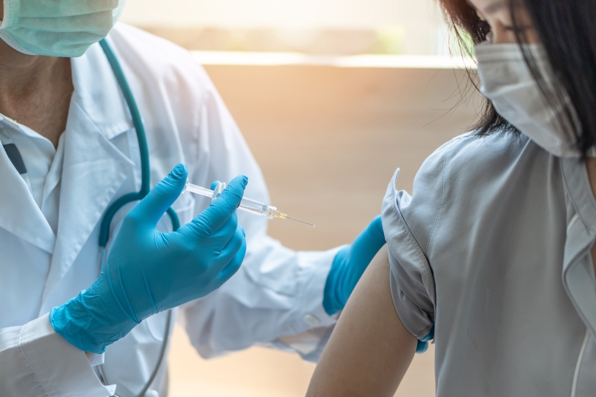 young woman having vaccine injection