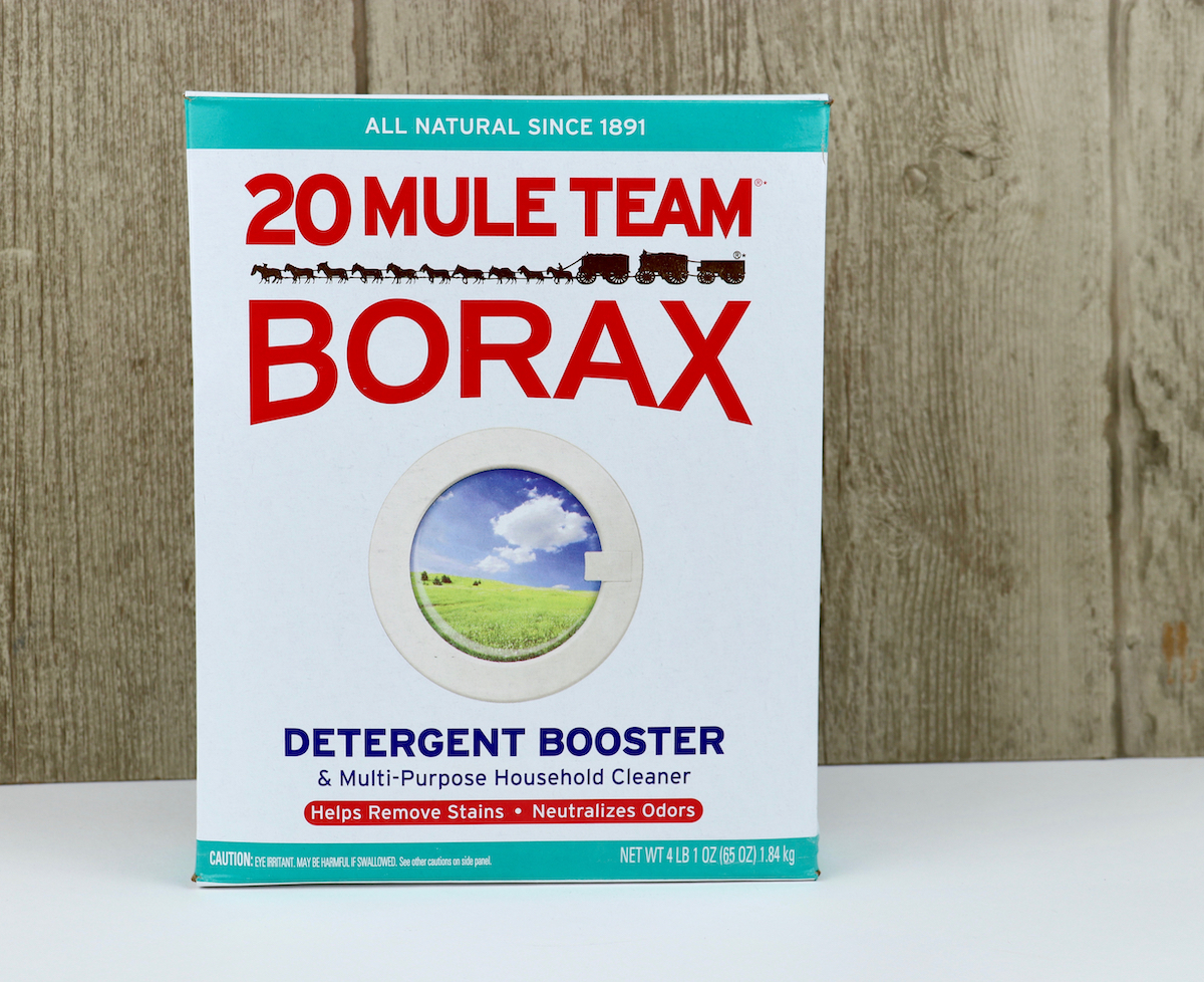 Box of Borax on white surface with wood background