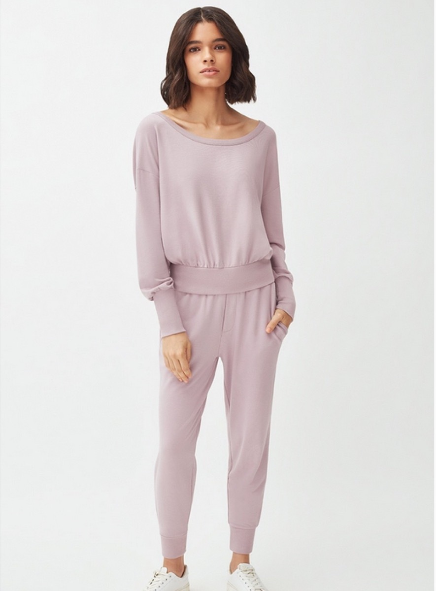 young woman in purple jumpsuit