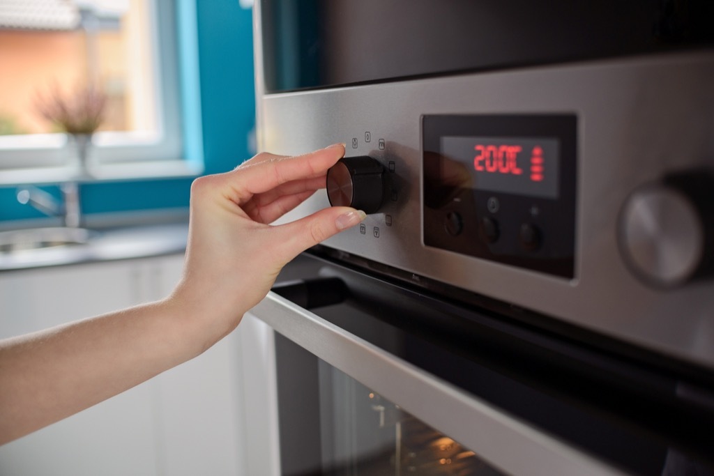 woman preheating oven