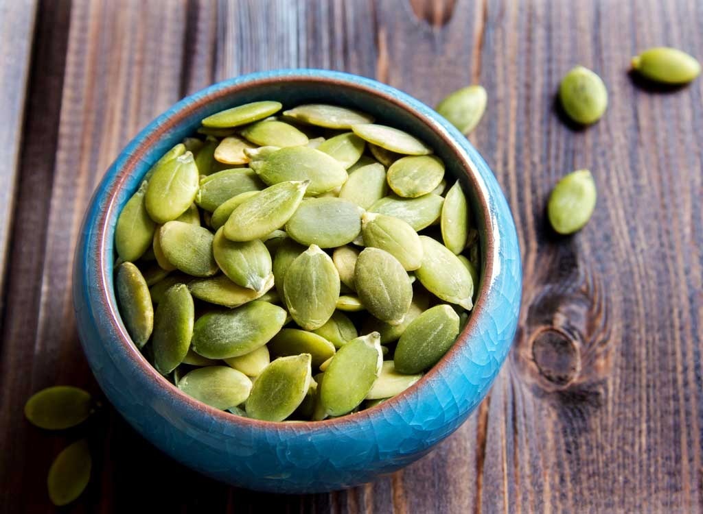 Pumpkin seeds in blue bowl iron rich foods