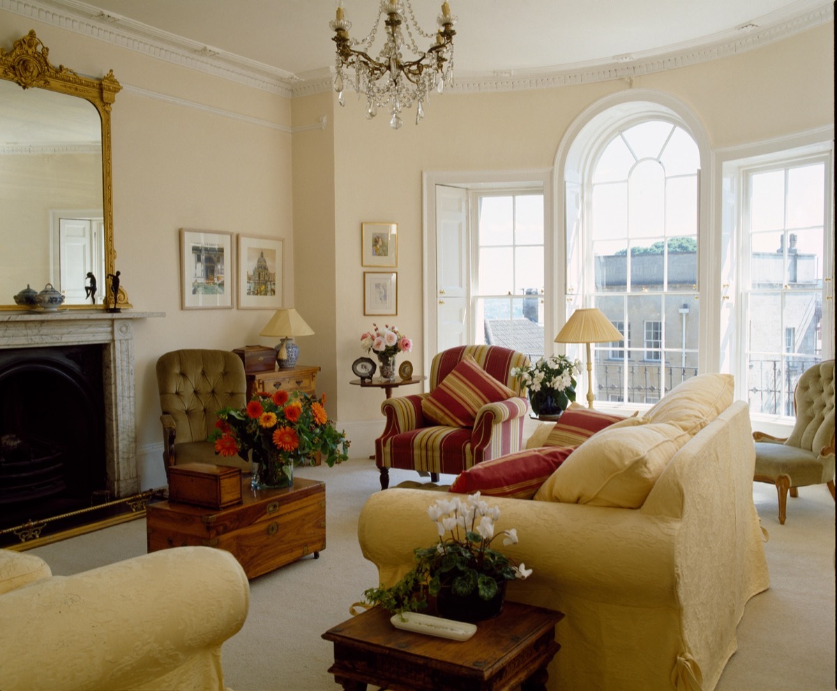Cream sofa in townhouse sitting room with an arched window