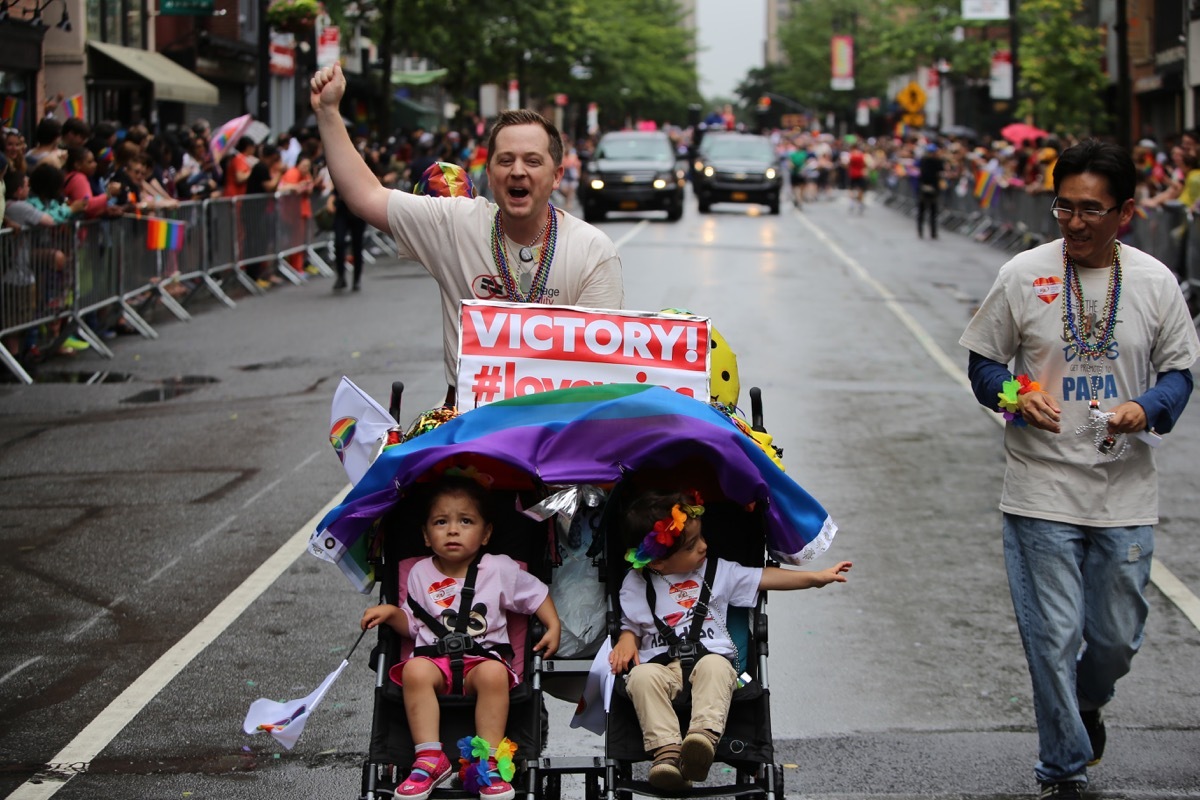 gay couple celebrates marriage eguality with children at new york city pride parade photos from pride celebrations