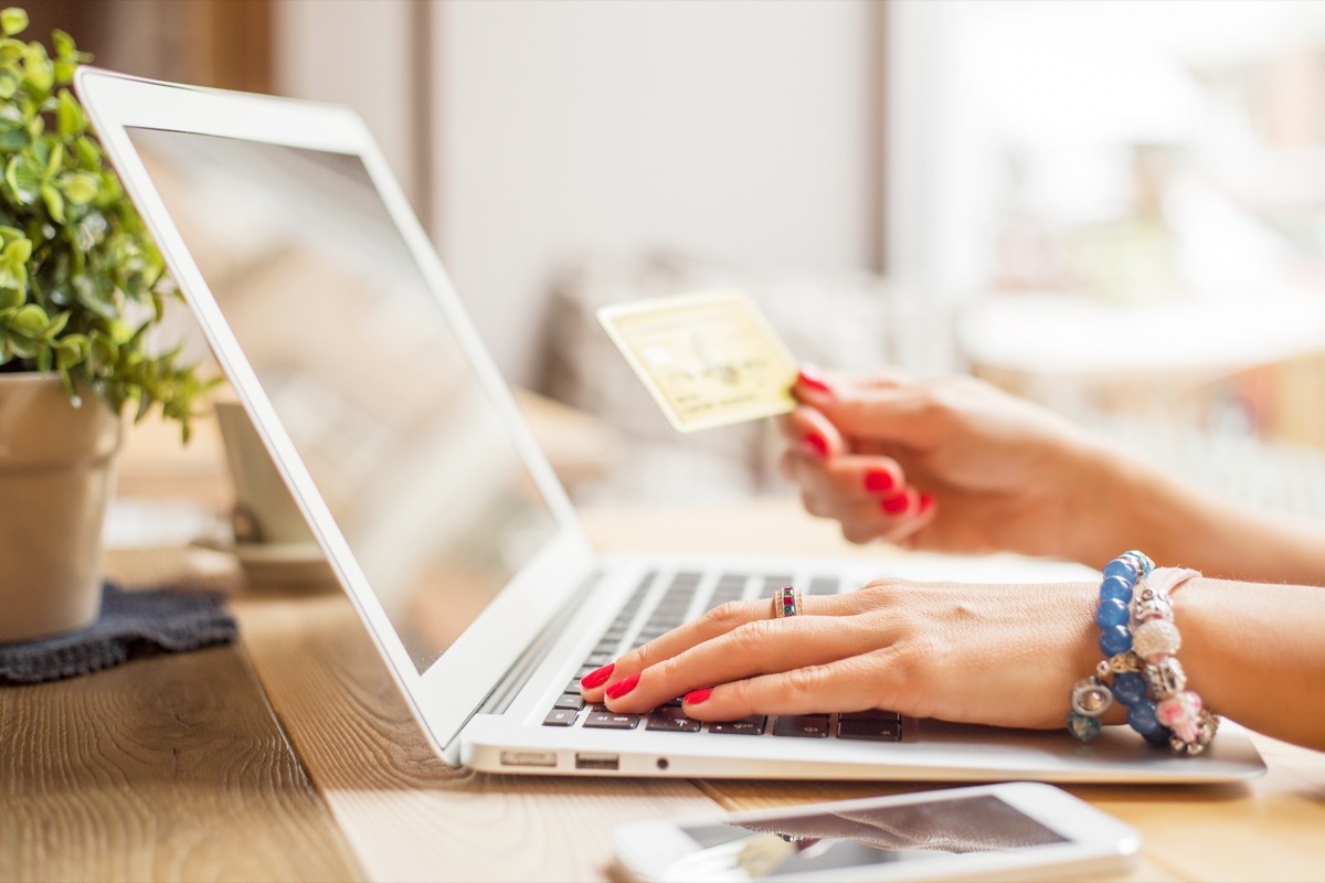 woman shopping online with a laptop and a credit card
