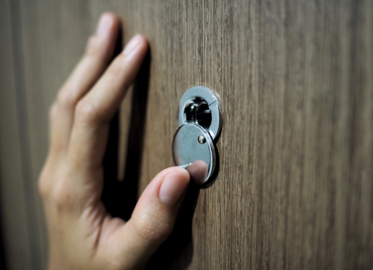 looking through peephole on door