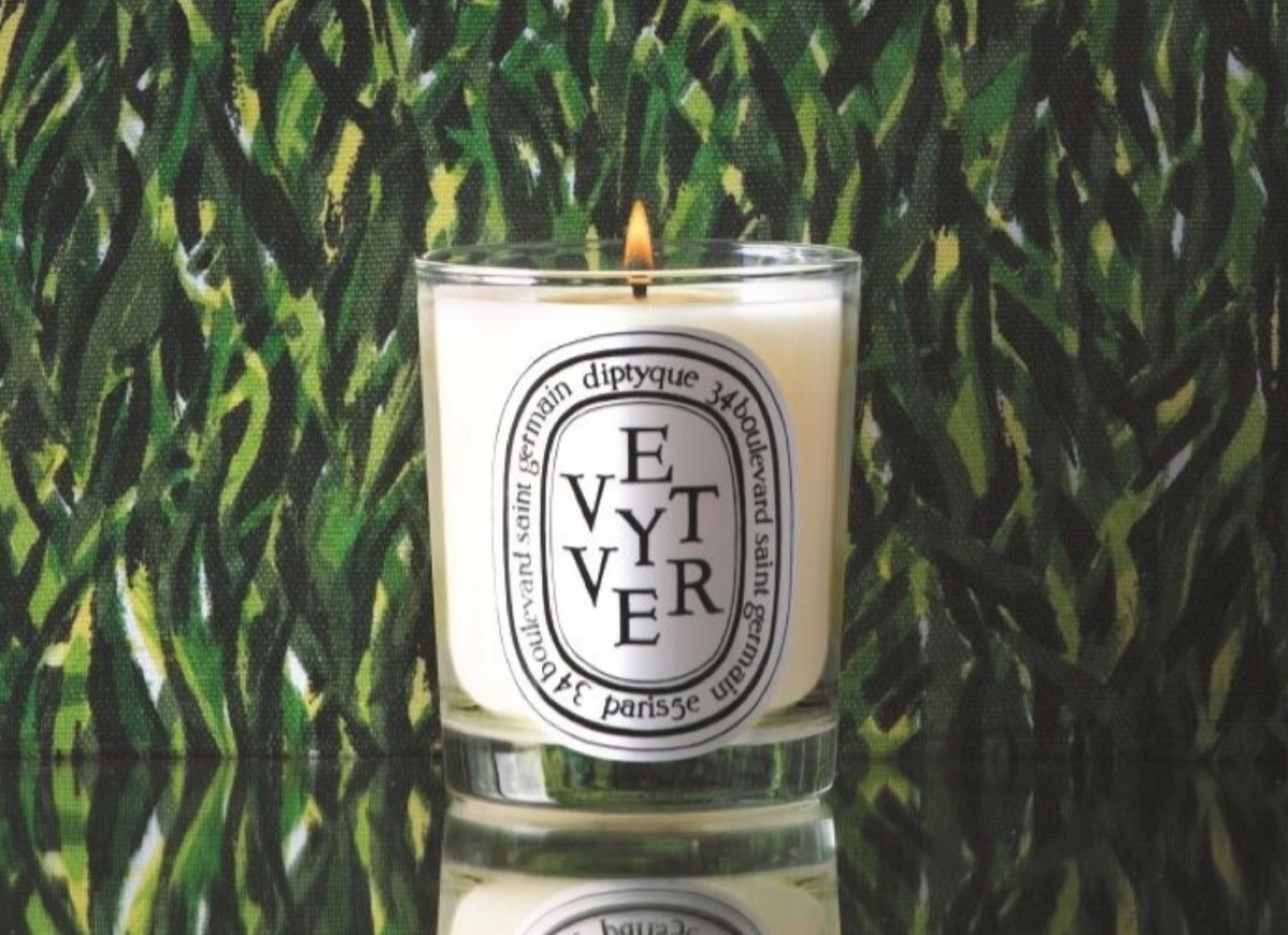 diptyque vetiver candle in front of green background