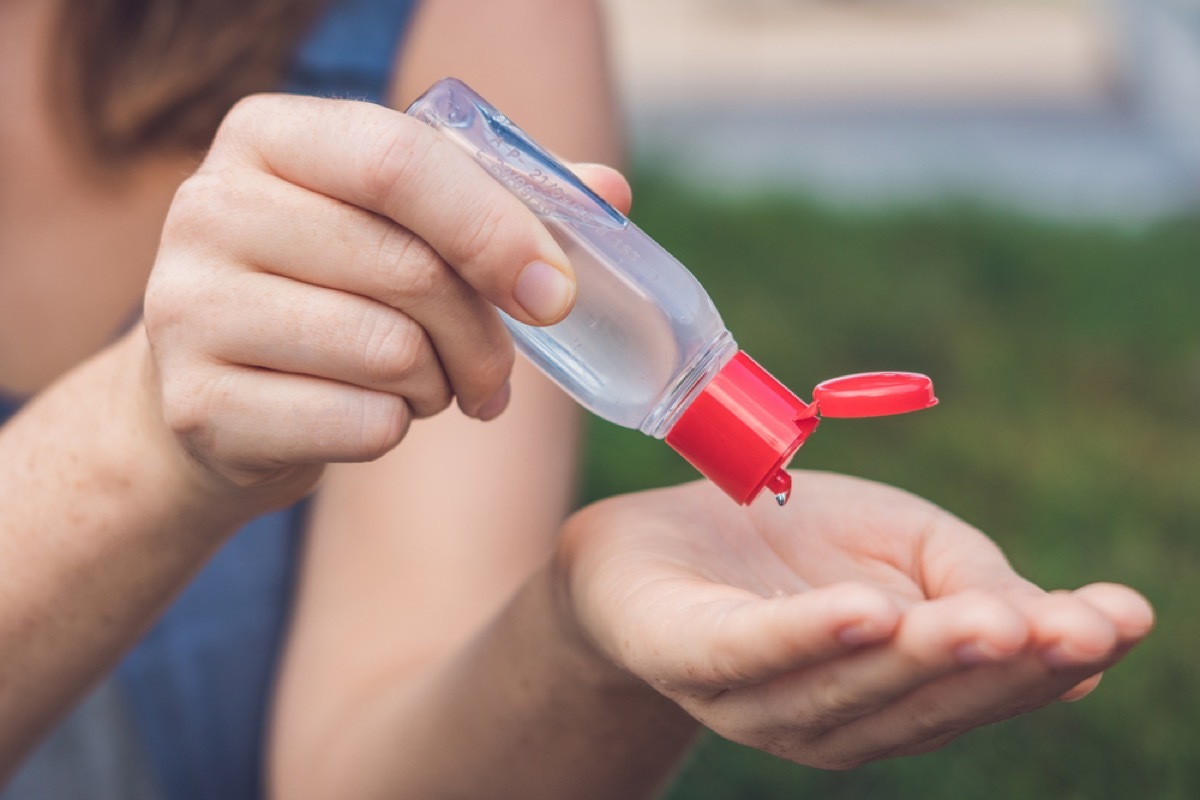 woman using hand sanitizer