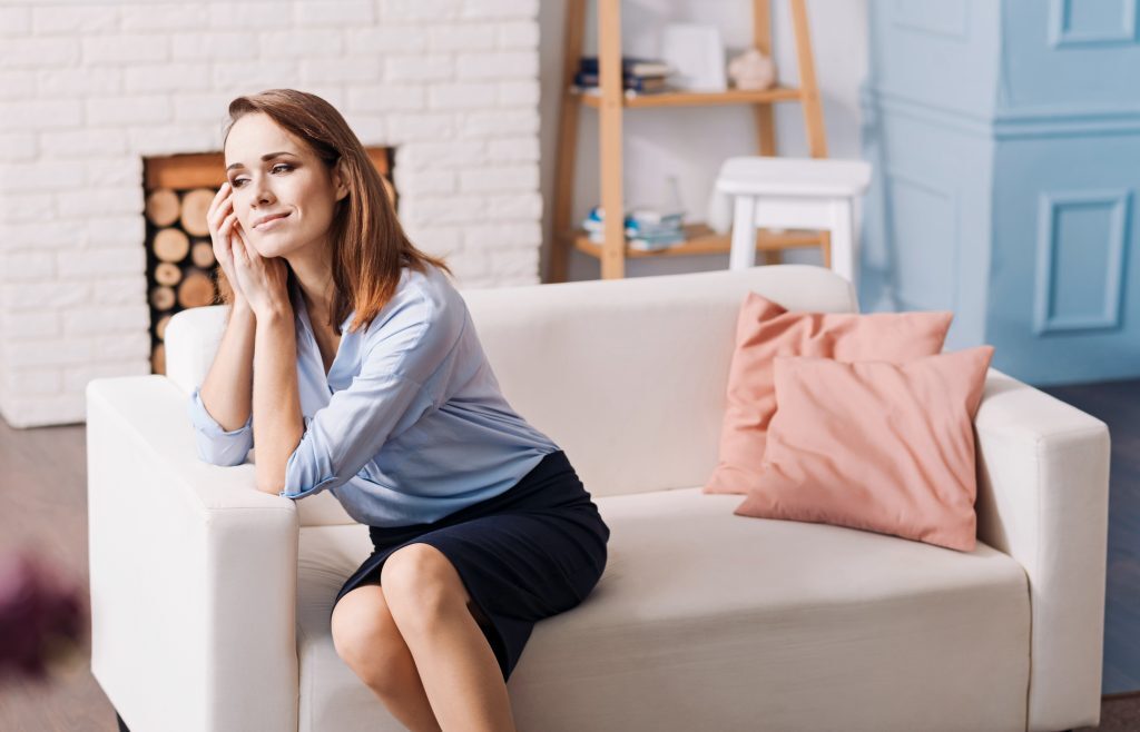woman looking longingly on couch, things divorced people know