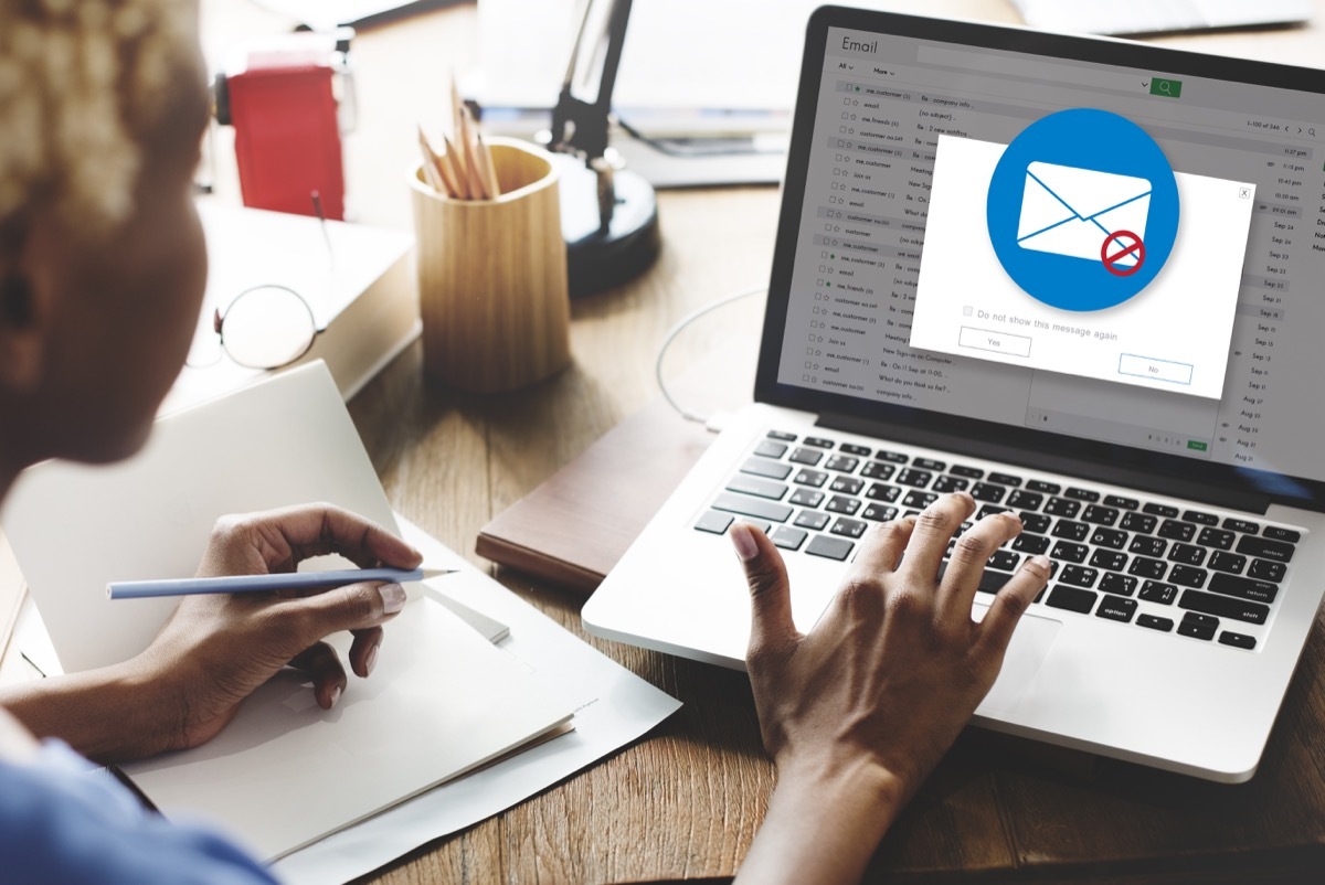 A woman opening up a scam email