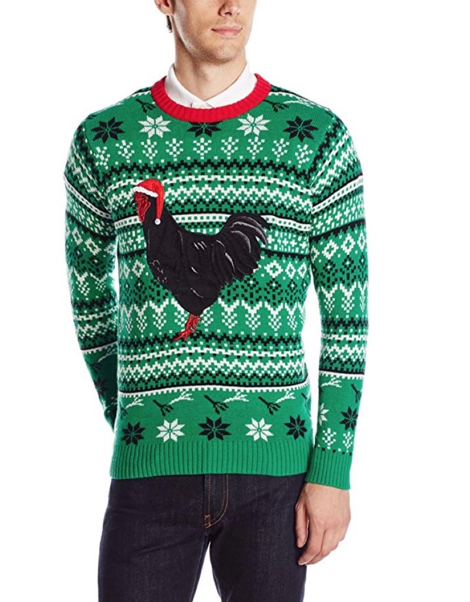 green christmas sweater with black chicken on it