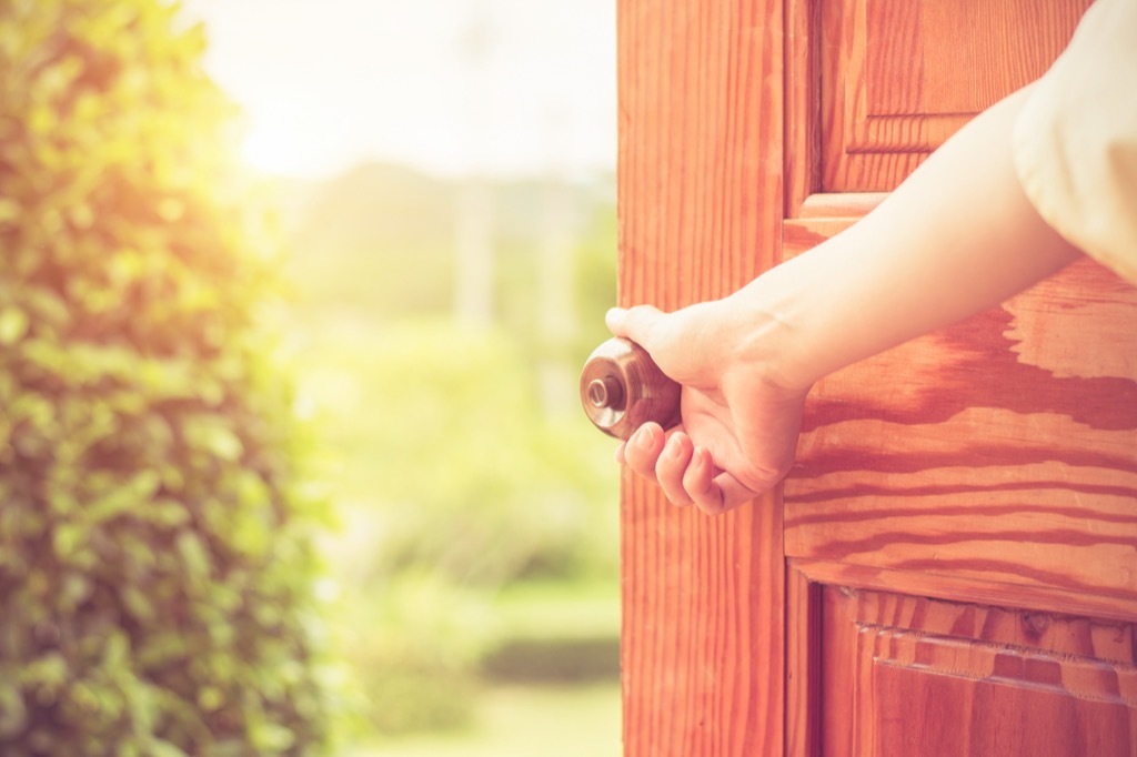 doorknob woman opening door home problems