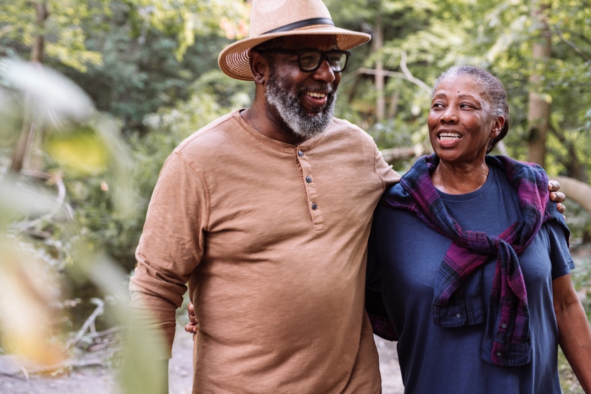 Smiling senior couple walking in a garden