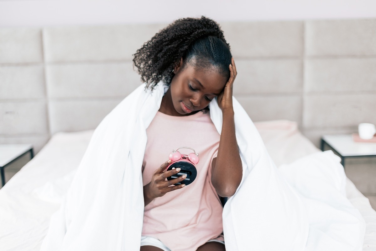 Tired Woman Holding Her Alarm Clock Habits That Horrify Physician