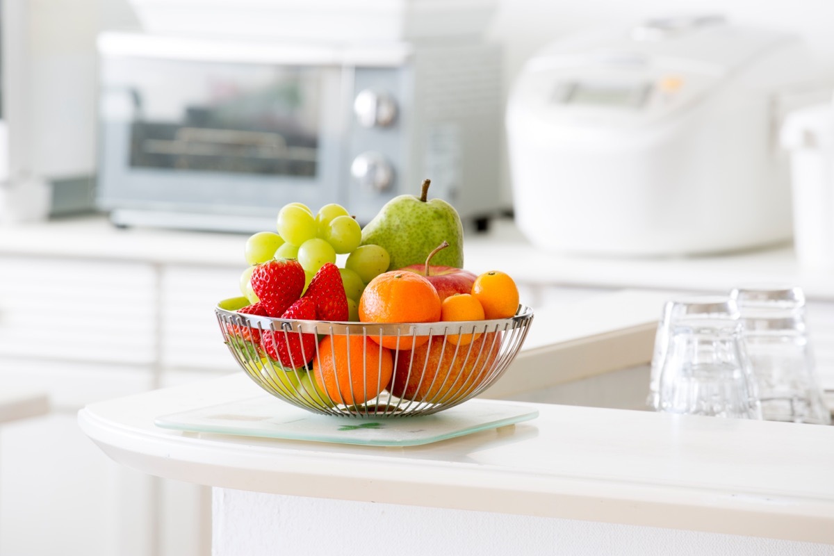 Basket of fruit in white kitchen