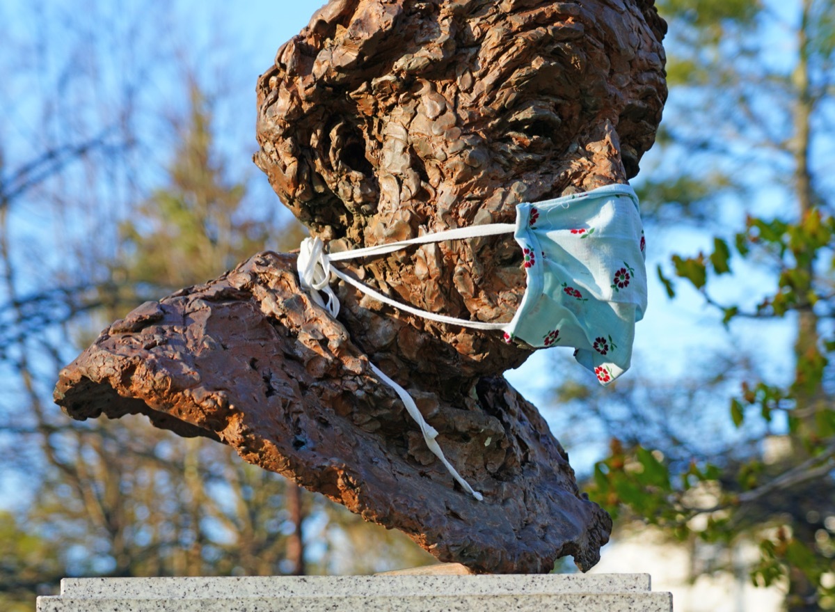 View of the statue of Albert Einstein on EMC Square in Princeton, New Jersey, covered with a cloth face mask
