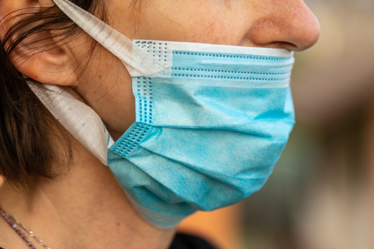 Woman wearing mask wrong below her nose