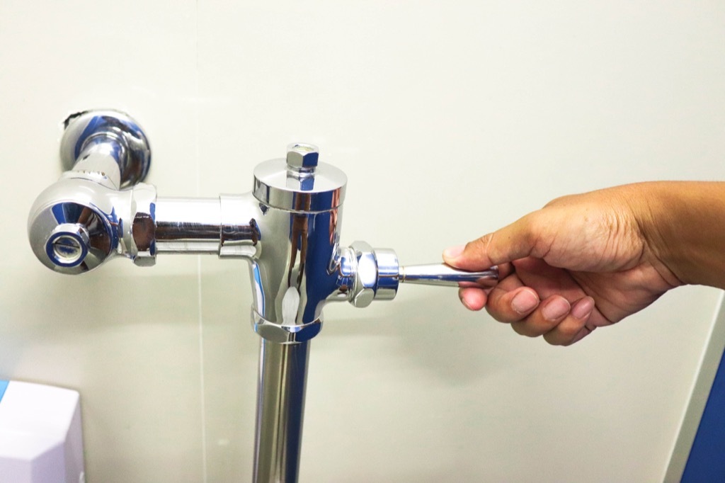 Hand flushing public toilet