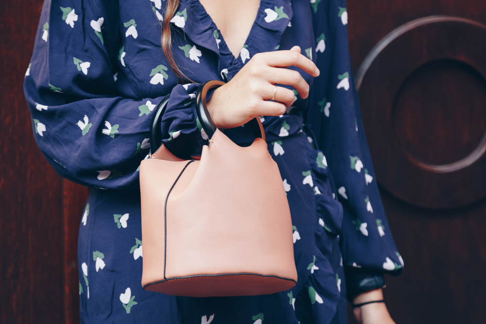 Stylish woman wearing printed or patterned blue wrap dress