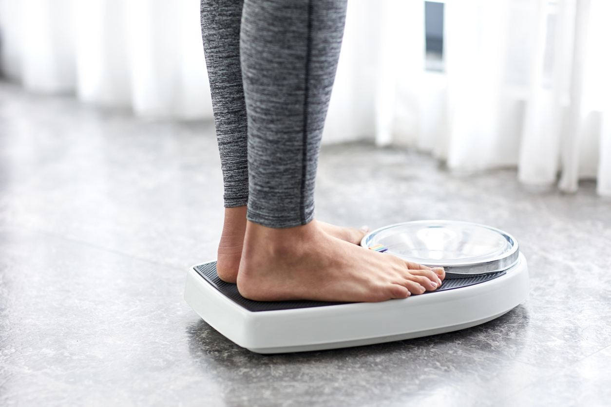 Person standing on home weight scale.