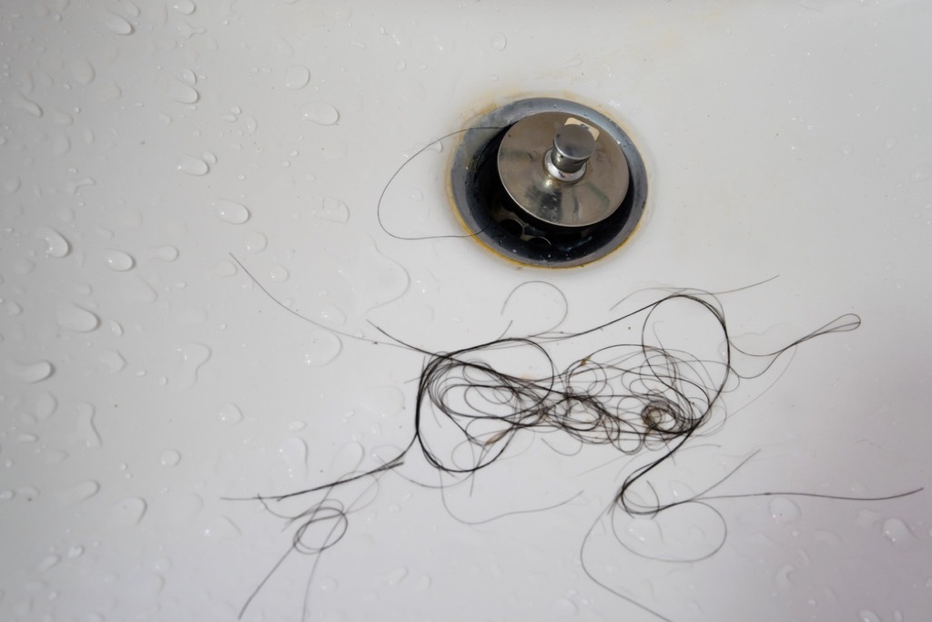 clogged drain and clump of hair, things housekeepers hate