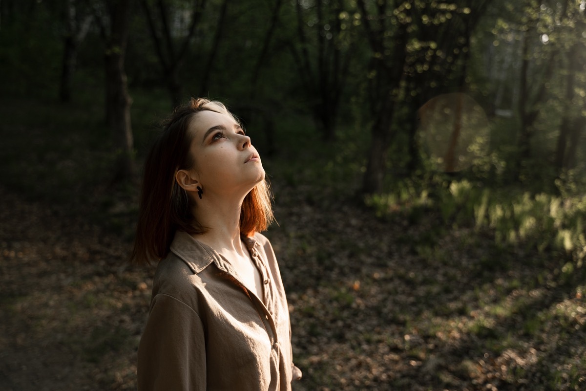 Woman looking at the trees