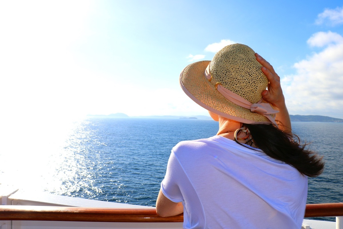 Beautiful young woman enjoying her vacation on a luxury cruise