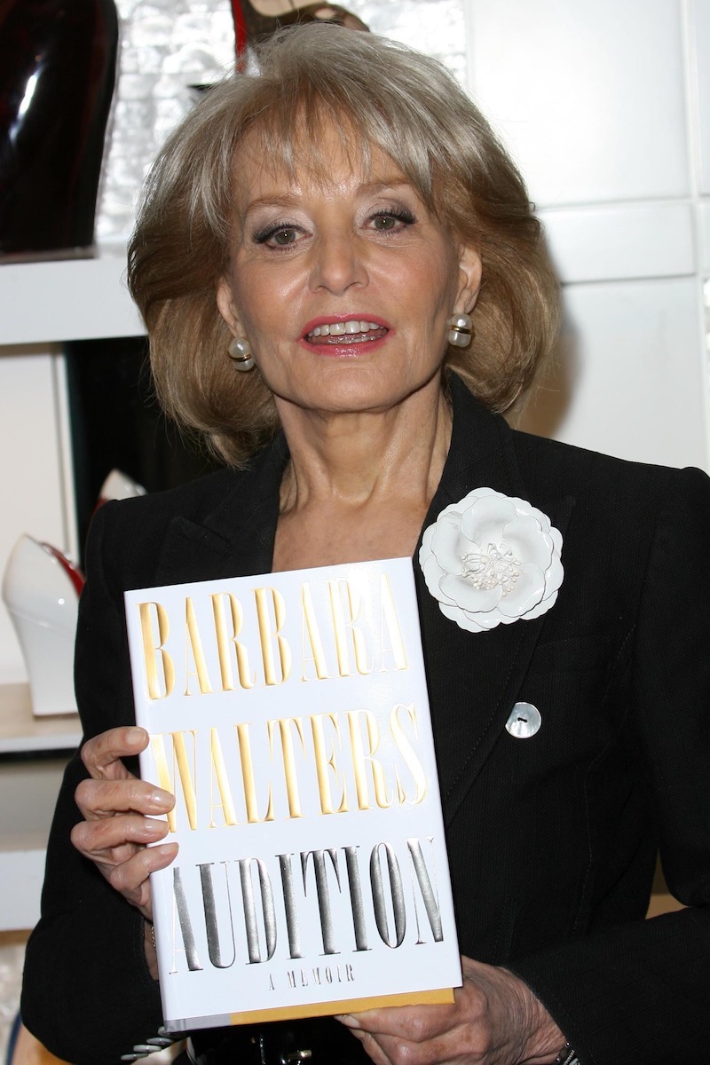 Barbara Walters holding her book