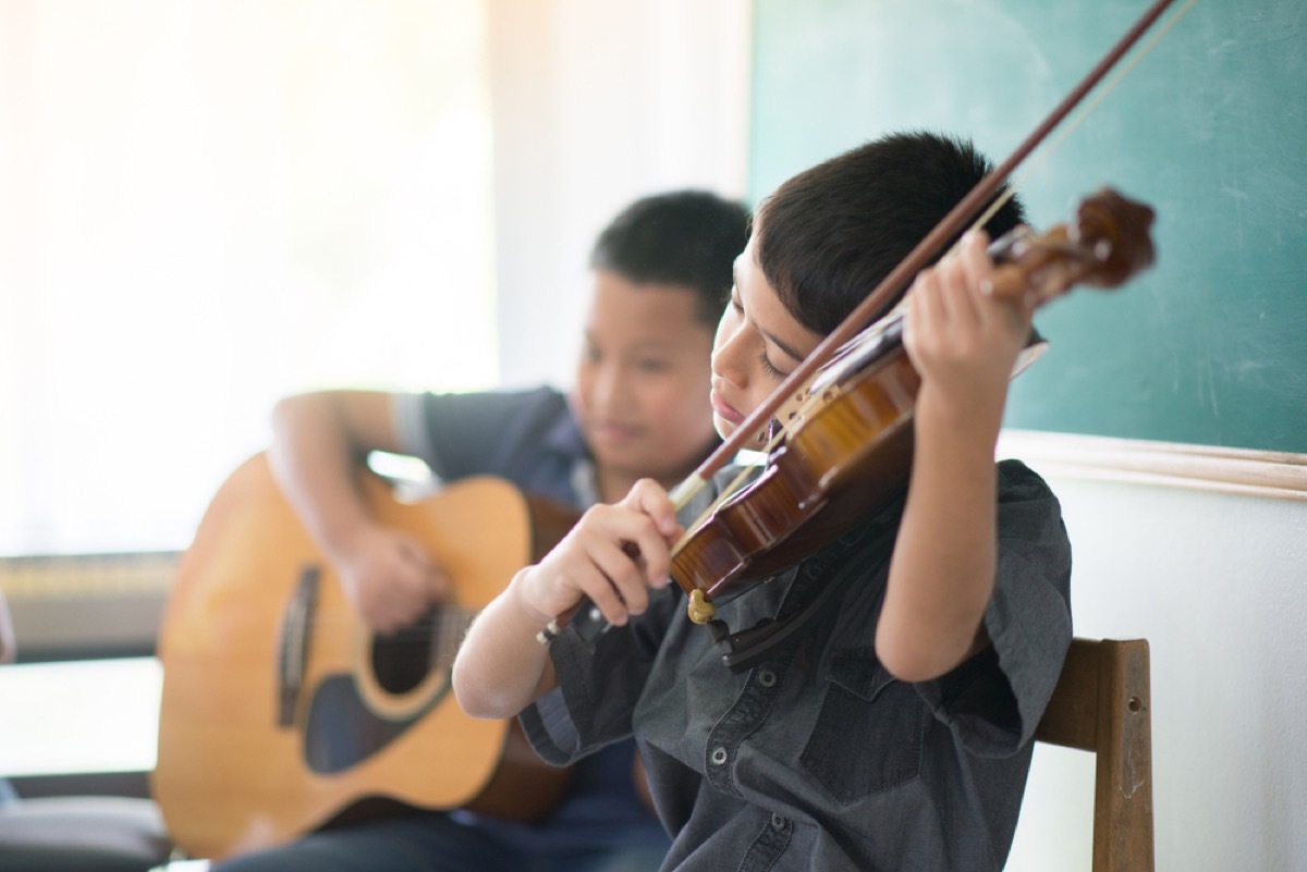 two young boys playing violin and guitar, parenting is harder