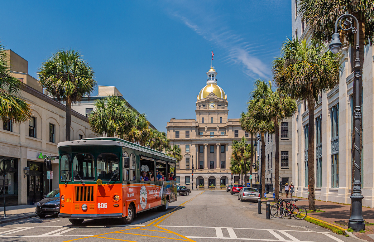 A view of the historic architecture and trolley in Savannah, Georgia.
