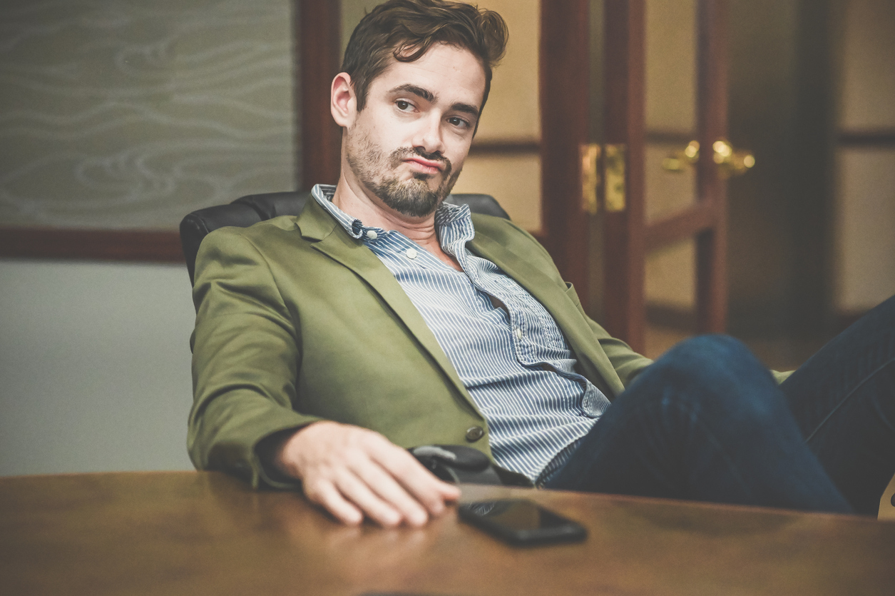 smug guy sitting in office chair