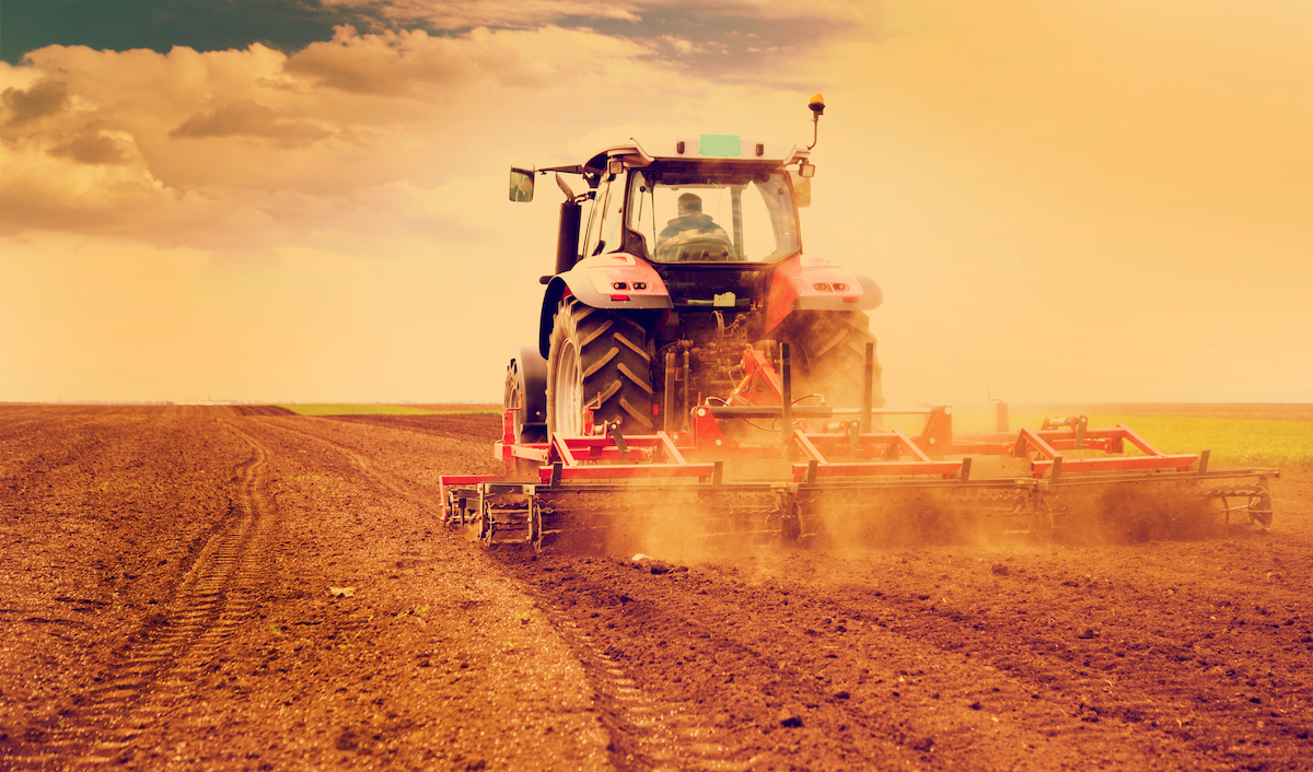 Farmer plowing field in a tractor