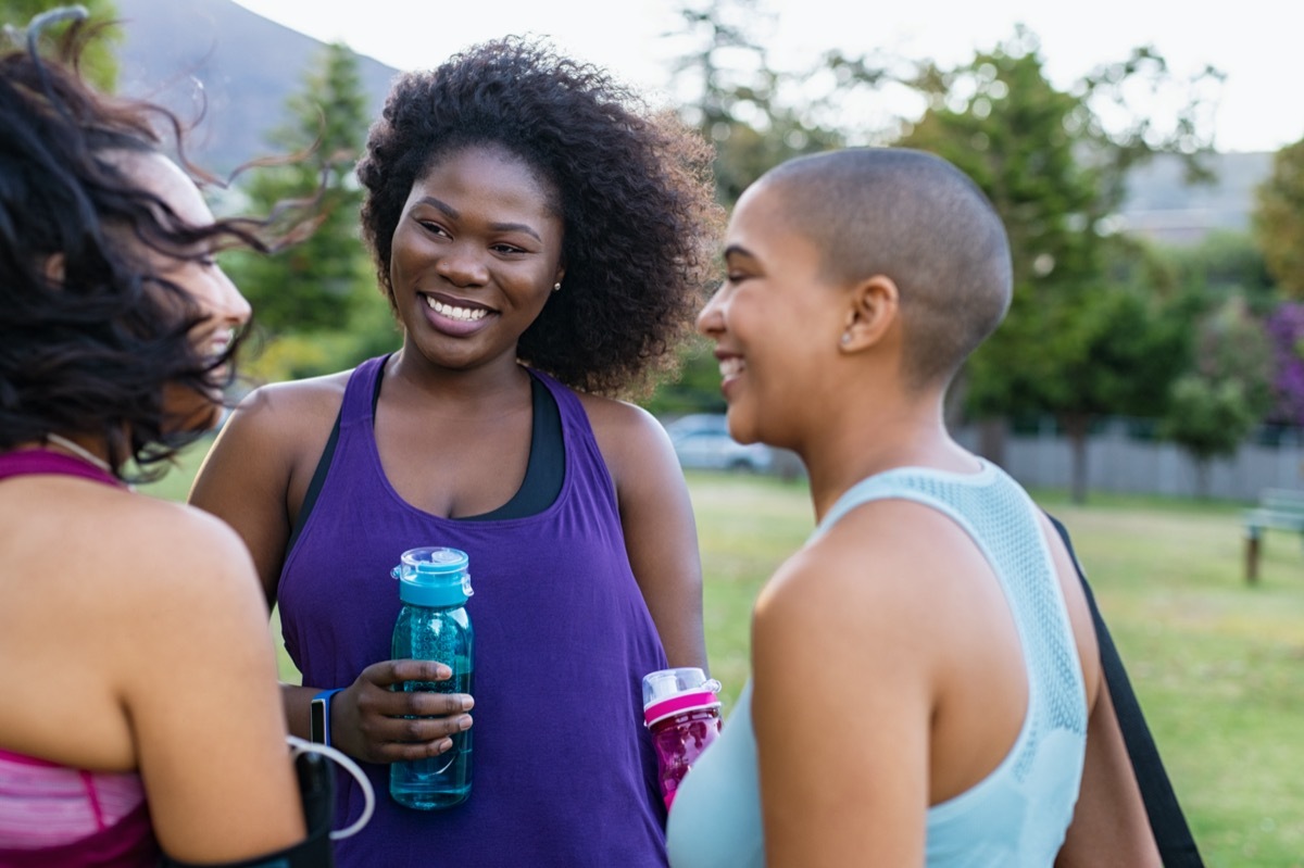 group of multiracial female friends talking outdoors