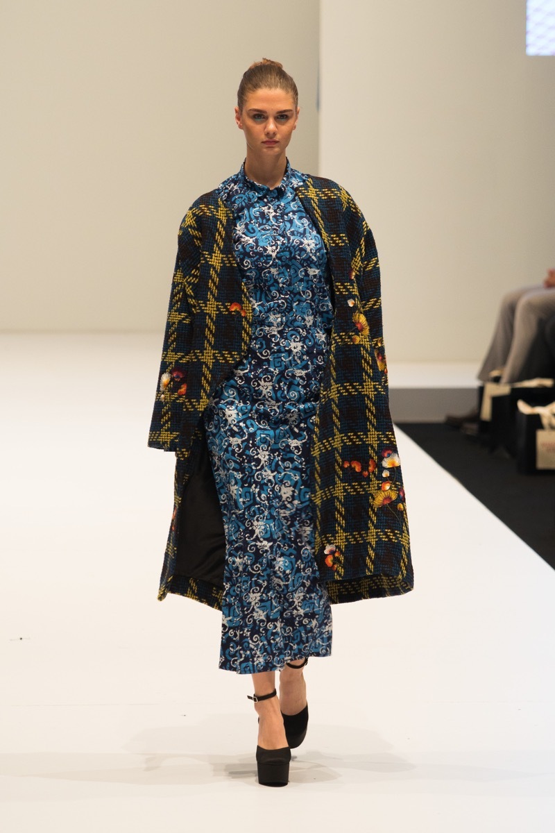 Kuala Lumpur, Malaysia - August 8, 2018 ; Model walks on white catwalk in Fashion Show of Autumn / Winter KL Fashion Week 2018 in 