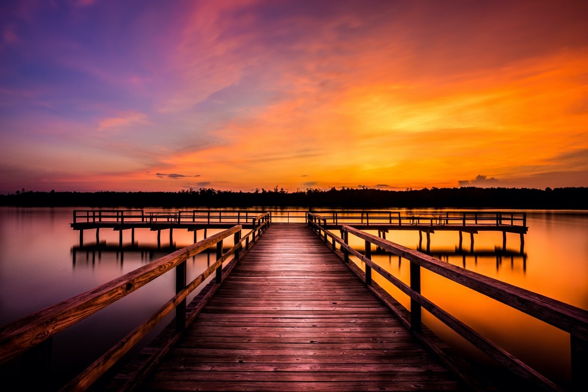 dock and Elvis Presley Lake in Lee County, Mississippi at dusk
