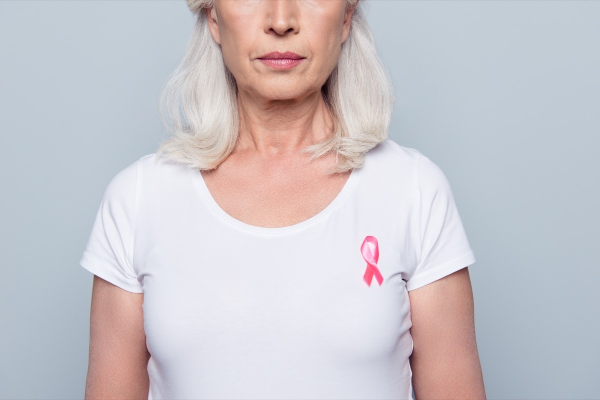 woman in white t-shirt with breast cancer pink ribbon