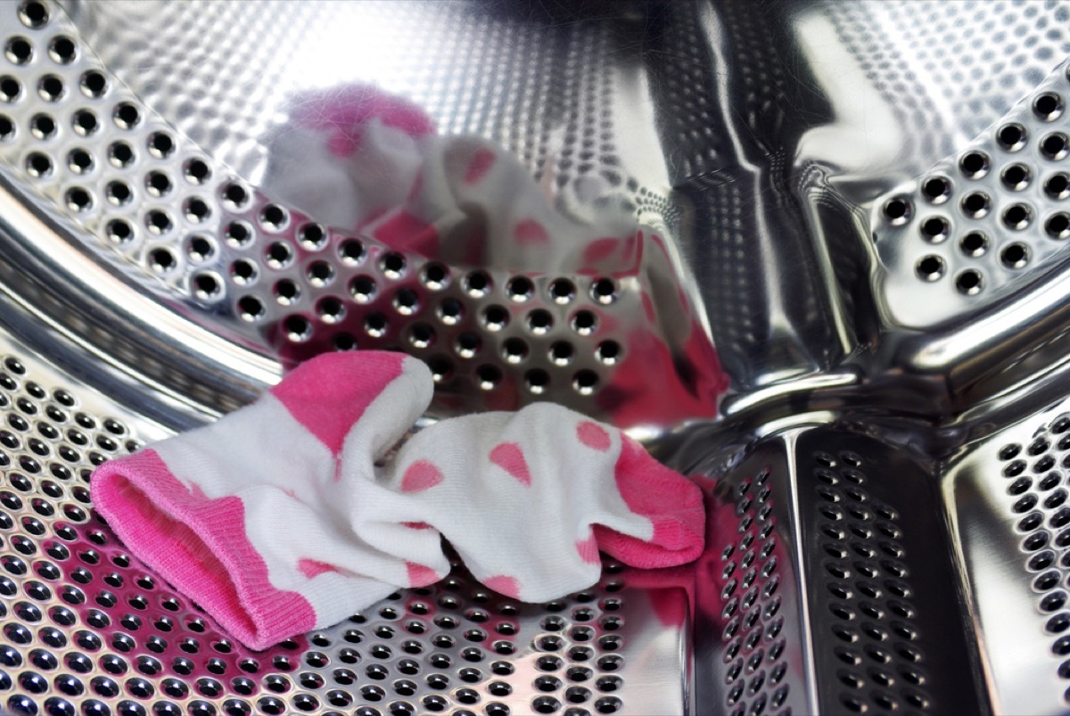 White and pink sock in the barrel of a dryer